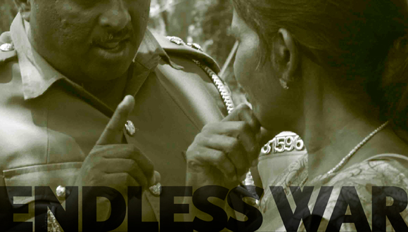 Police warning communities protesting in front of an army camp demanding release of their land