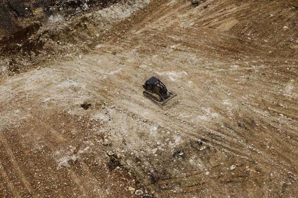 A bulldozer flattens the earth after forests have been cleared in West Pomio. Credit: Paul Hilton / Greenpeace