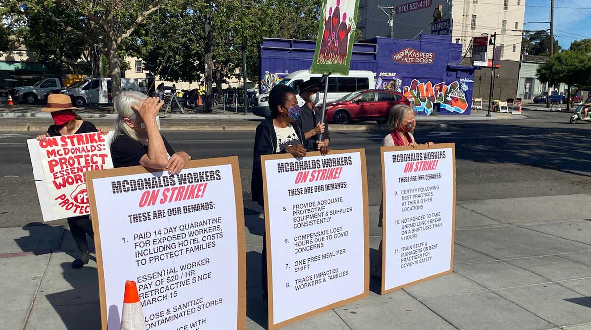 Faith and community leaders holding signs at the June 5, 2020 protest outside of the McDonalds in Oakland, California.