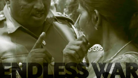 Police warning communities protesting in front of an army camp demanding release of their land