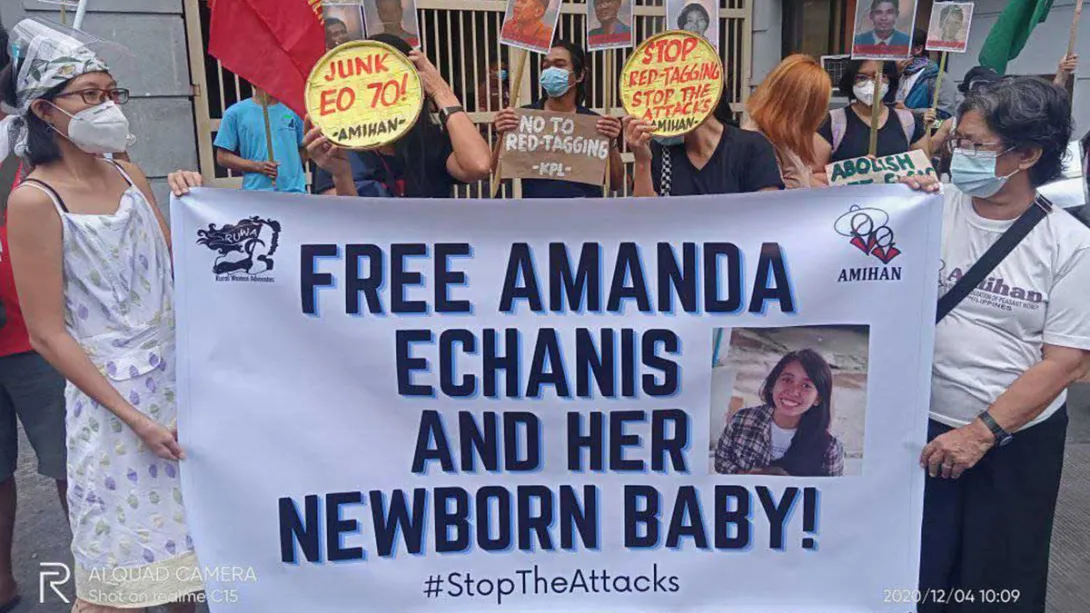 Protesters holding banner "Free Amanda Echanis and Her Newborn Baby! #StopTheAttacks"