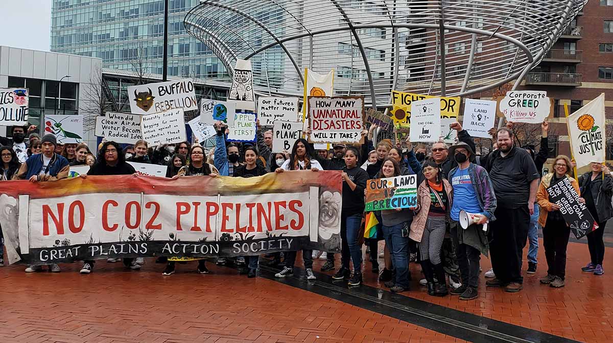 Protestors from several Indigenous and BIPOC groups with signs and banners.