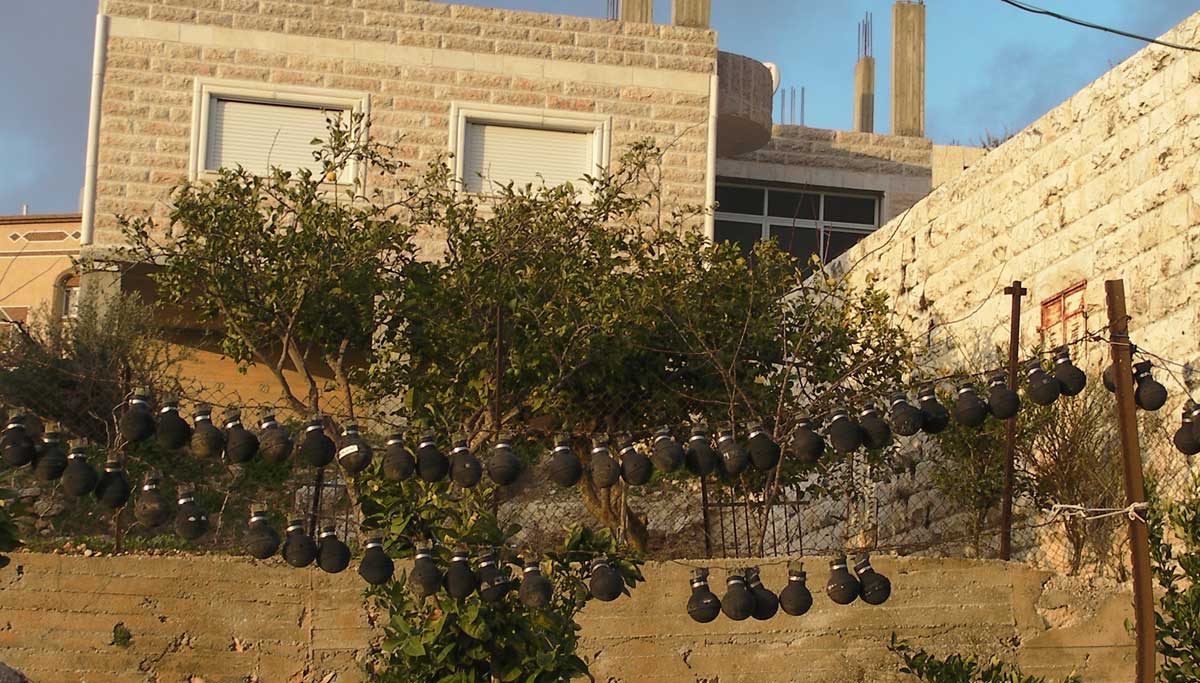 Used IDF gas canisters on garden fences in Nabi Salih. Credit: The Oakland Institute