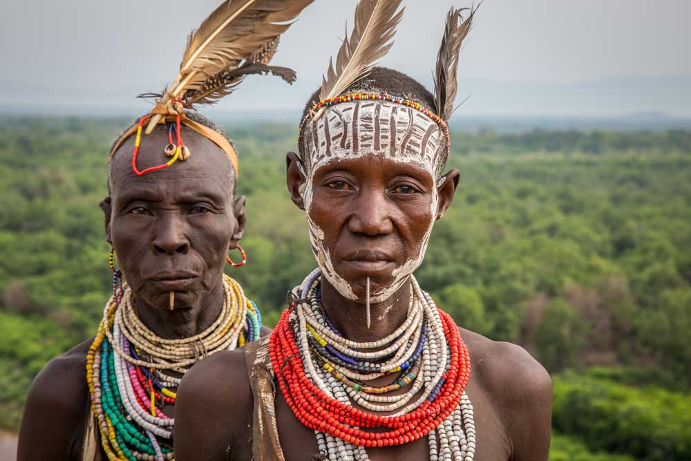 Two Kara women standing by the Omo River, April 2018 © Kelly Fogel Two Kara women standing by the Omo River, April 2018 © Kelly Fogel