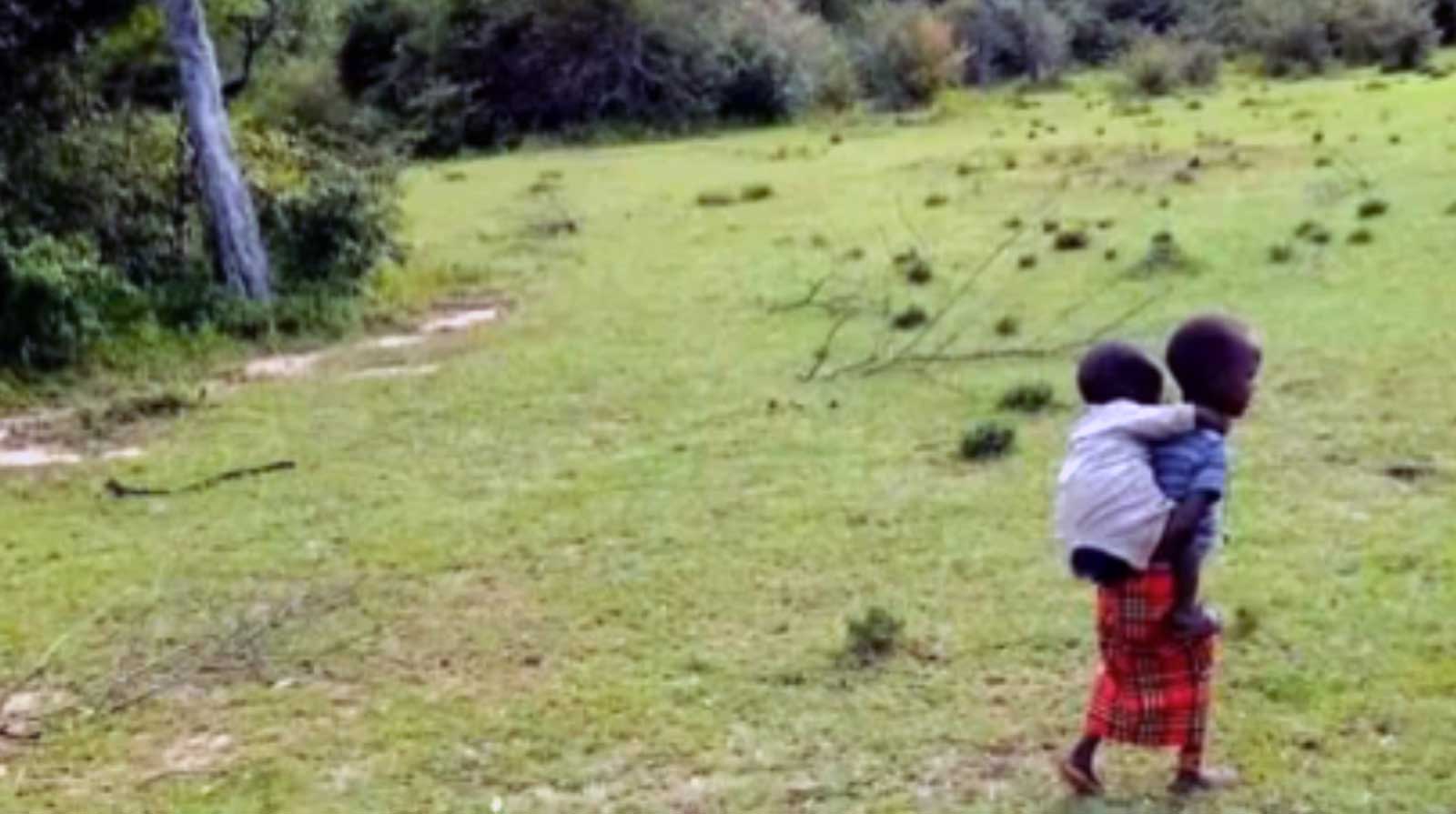 Displaced child caring for his younger brother. 