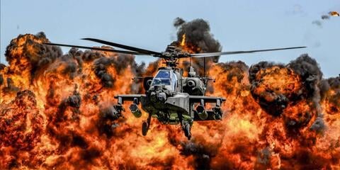 Helicopter with fiery explosion in background